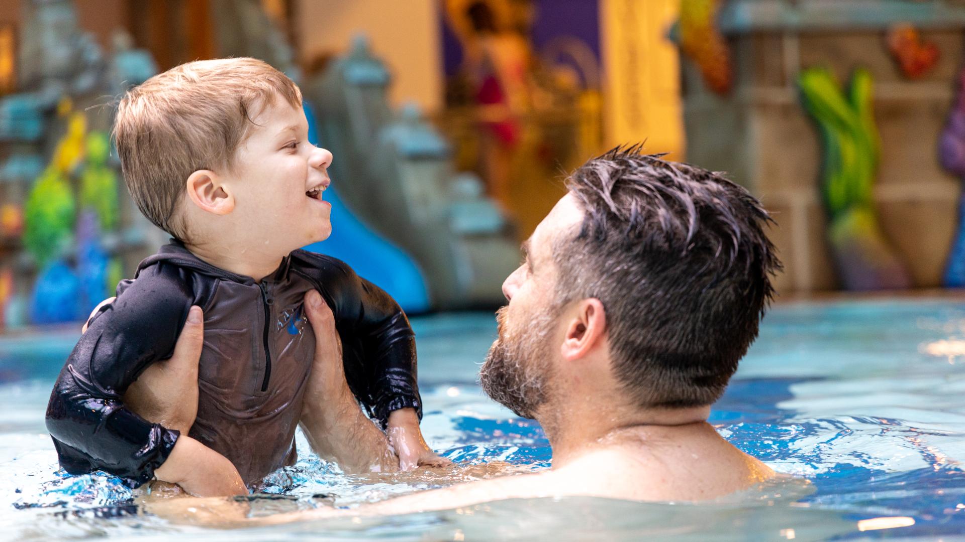 parent and toddler in swimming pool